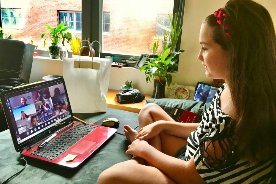 woman in black and white zebra print shirt using macbook pro