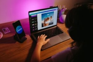 girl using canva website on laptop